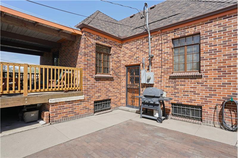 Brick patio outside kitchen and next to breezeway