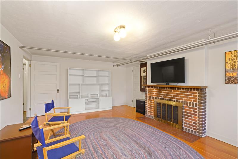 Basement family room has 2nd wood-burning fireplace