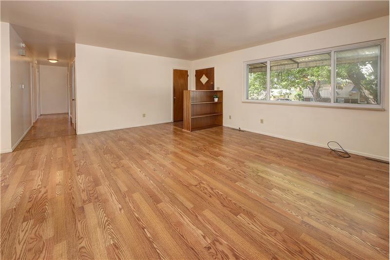 Large vinyl window in living room with a view of the large mature tree in the front yard
