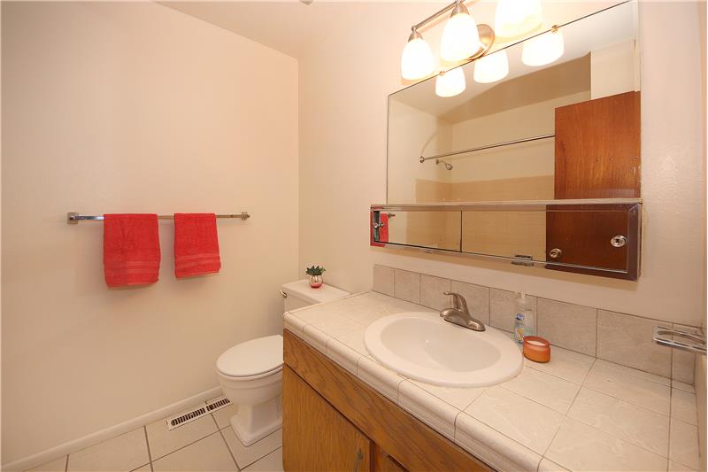 Full bath on main level with tile floor and tile counter top
