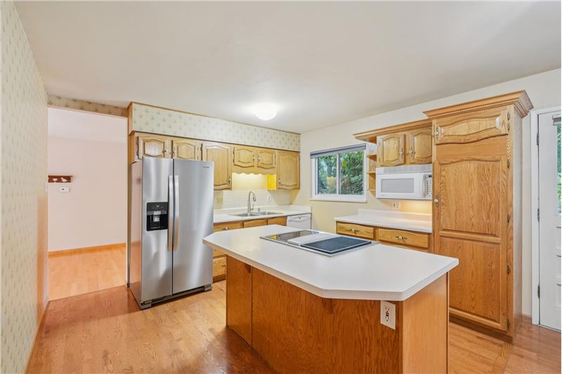 Kitchen with dining room beyond, pantry at right