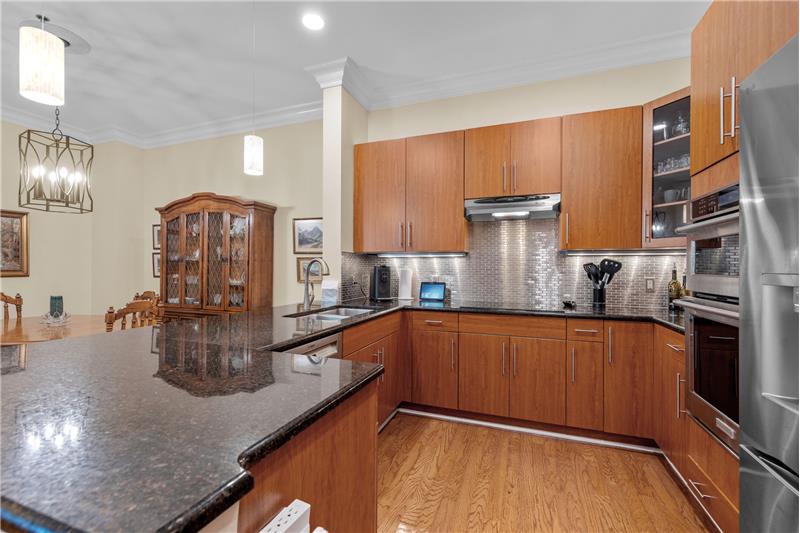 Kitchen features an induction cooktop, wall oven, microwave, French door fridge, dishwasher