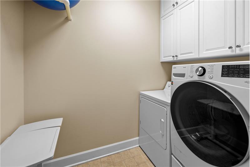 A separate laundry room with storage, closet, and room for large, front load washer/dryer