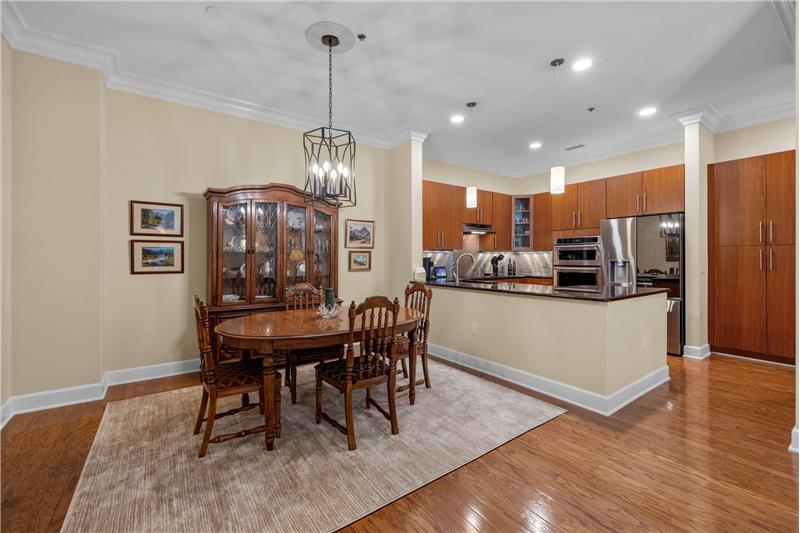 Dining area allows for seamless meal preparation and serving, while maintaining a distinct space for dining