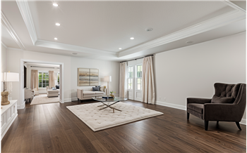 virtually staged living room going leading into the kitchen