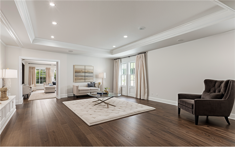 virtually staged living room going leading into the kitchen