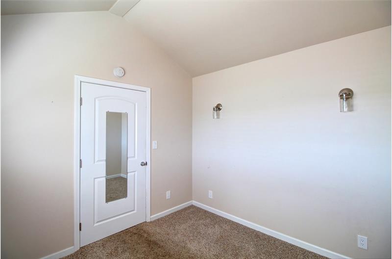 West facing Bedroom 2 is off the bathroom, and enjoys vaulted ceilings and more wall sconces....