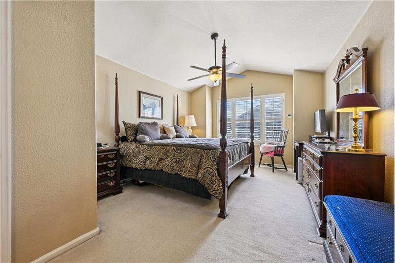 Primary bedroom with vaulted ceiling 