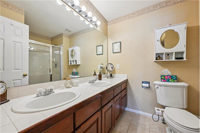 Ensuite primary bathroom with dual vanity and shower