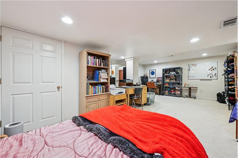 Reverse view of basement bedroom. Utility room at left