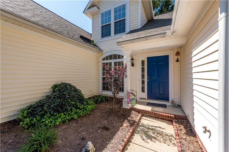 Lovely landscaping provides a welcoming introduction to the home.