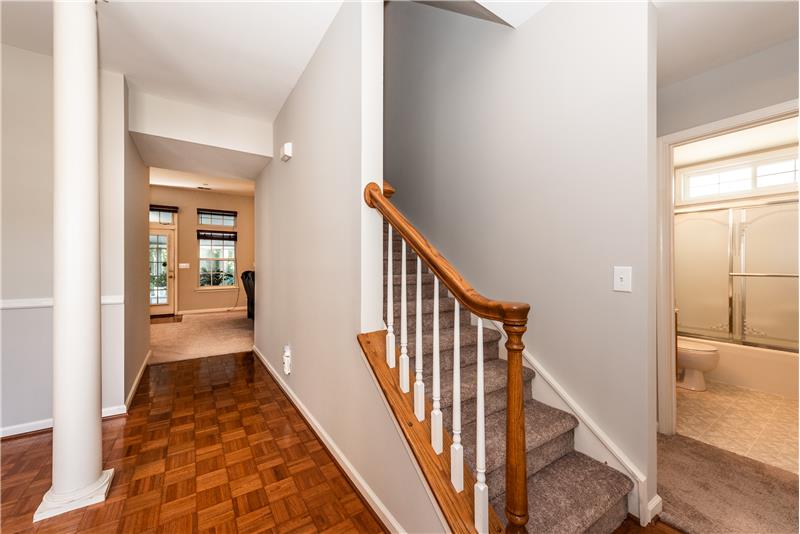 Center hall style foyer with dining room to the left and secondary bedrooms and bathroom to the right.