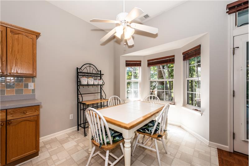 Nestled by a bay window overlooking the private, wooded back yard. Ideal for daily dining and casual entertaining.
