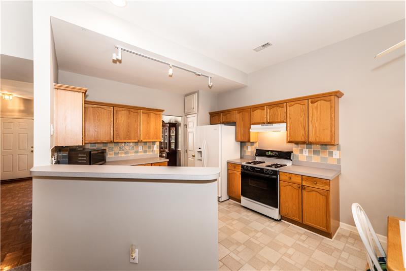 Freshly painted kitchen with tile back-splash.