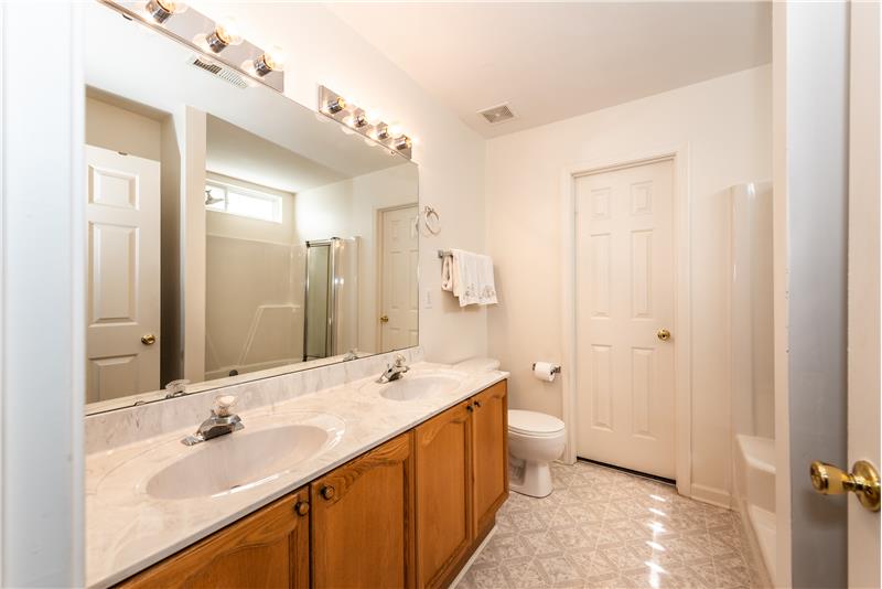 Owner's en-suite bathroom: double sink vanity with storage below, walk-in closet, linen closet.
