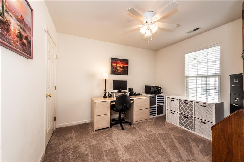 One of two secondary bedrooms on the main floor of the home with new carpet; currently utilized as a home office.