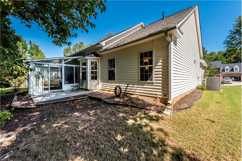 Back view of home. Easy-maintenance vinyl siding. In-ground irrigation + gutter guards.