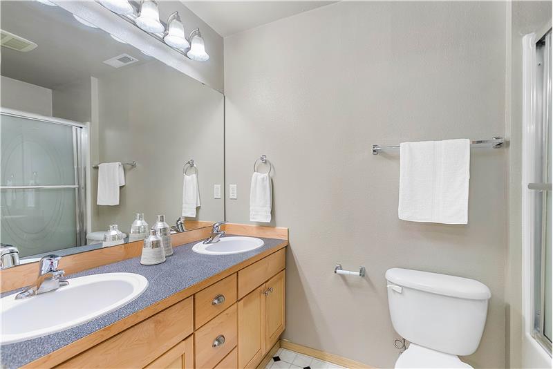 In the primary bathroom, you will enjoy double sinks.