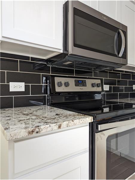 Granite counters and black subway tile