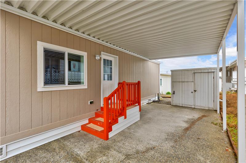 Spacious carport with storage shed fo your vehicles, bikes, and other toys.