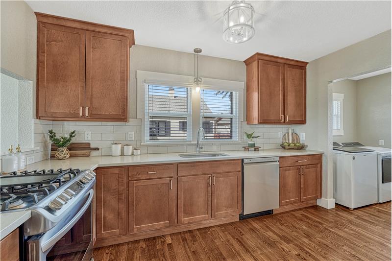 Updated kitchen with gas range oven, quartz counters, tile backsplash
