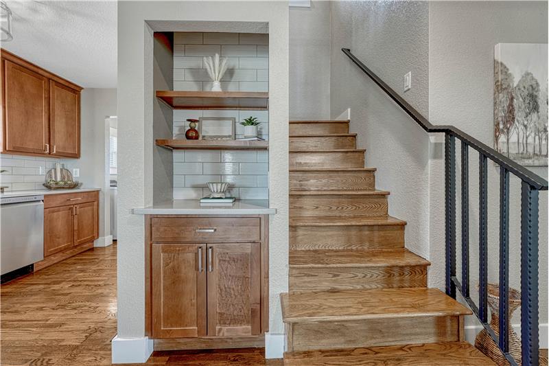 View of built-in shelving and stairs leading to upper level