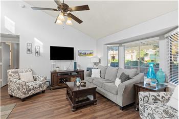 Large living room with vaulted ceiling and bump out