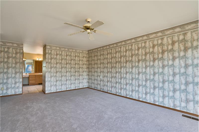 Another View of the Large Primary Bedroom with a View into the 5 Piece Bathroom.