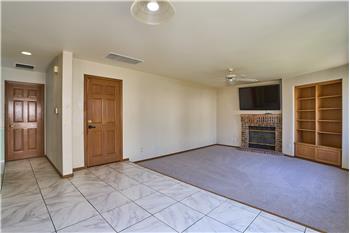 Another View of the Family Room with Brick Surround Gas Fireplace and Built-in Shelves.