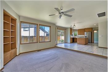 Family Room View with Built-In Shelves, Ceiling Fan. View looking into the Breakfast Nook and Kitchen.