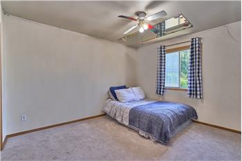 Second Bedroom with Ceiling Fan and New Carpet.