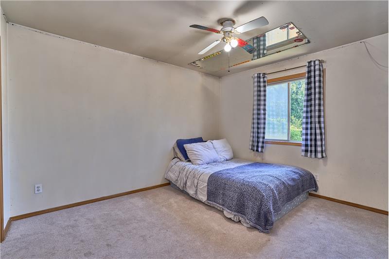 Second Bedroom with Ceiling Fan and New Carpet.