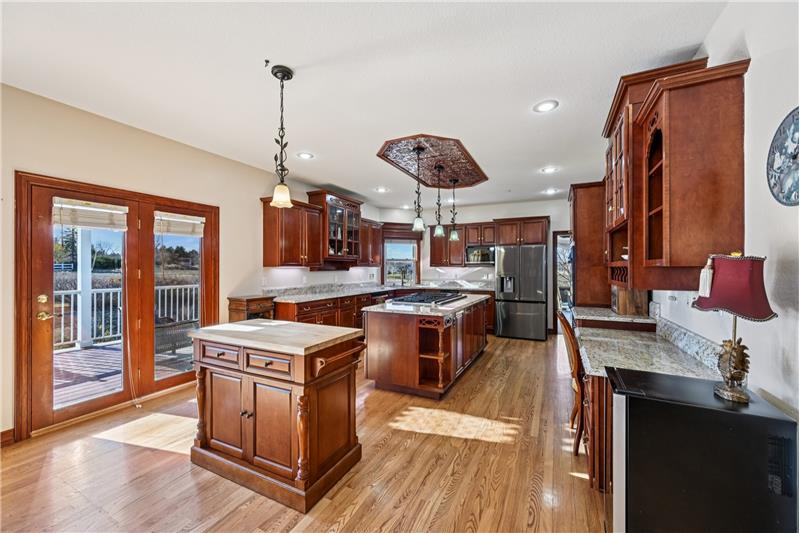 Long view of kitchen, showing door to deck and backyard