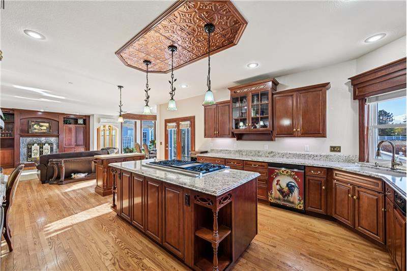 Kitchen viewed from door to living room, with family room beyond
