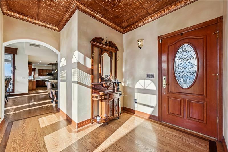 Inside the back door. Kitchen in distance, primary suite behind camera