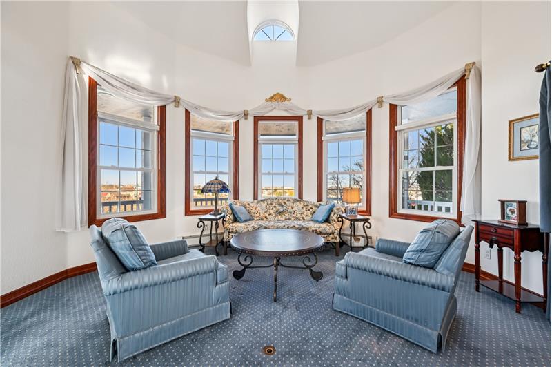Living room with bow windows to the wrap-around covered porch