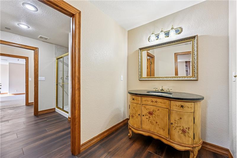 This is a vanity with door to the primary suite's bathroom but accessed from the living room/kitchen.