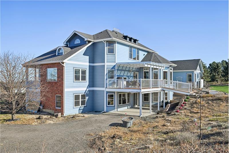 View from north. Entrance to basement unit is on patio under the deck