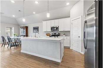 Island kitchen fully open to a large living area.