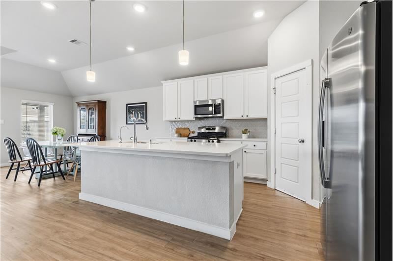 Island kitchen fully open to a large living area.