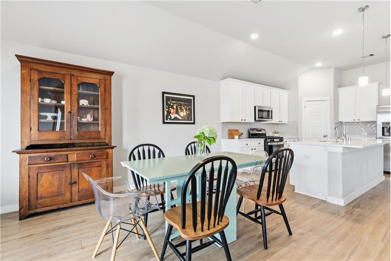 Casual dining area opens to living area and kitchen.