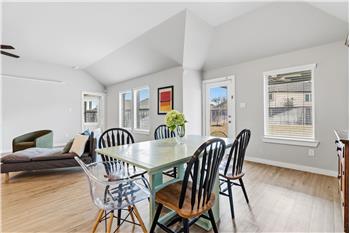 Wall of double paned windows with views into your backyard with extended covered patio.