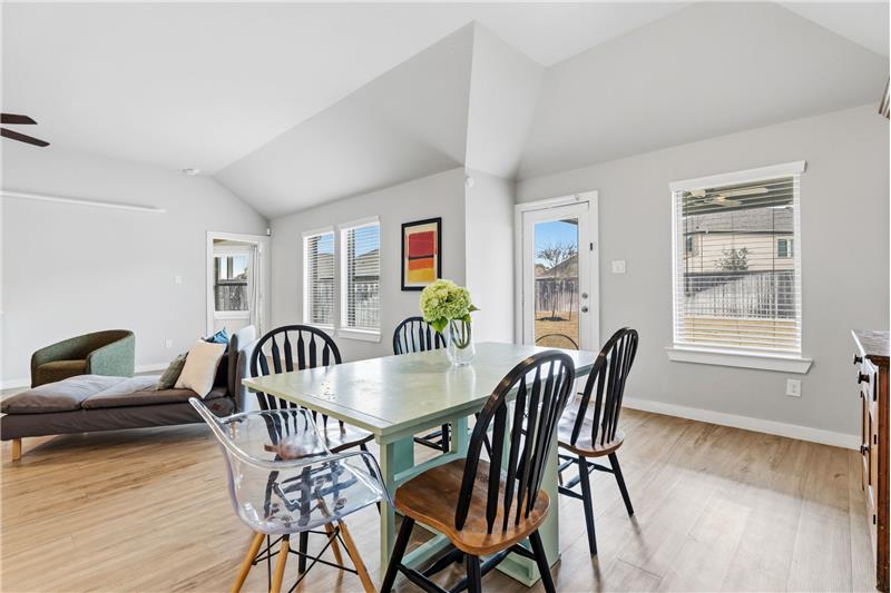 Wall of double paned windows with views into your backyard with extended covered patio.