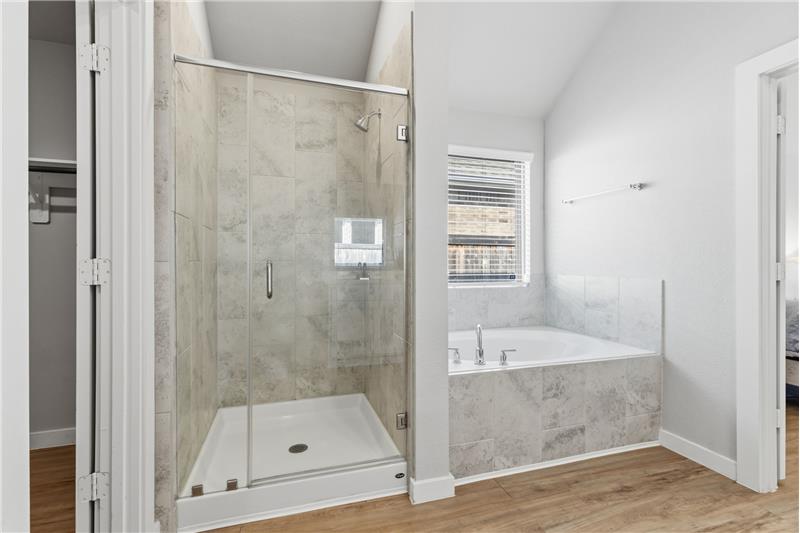 Primary bath with walk-in shower plus a soaking tub.