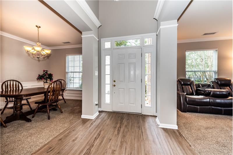 2-story foyer. Front door with sidelight and transom windows provides natural light.