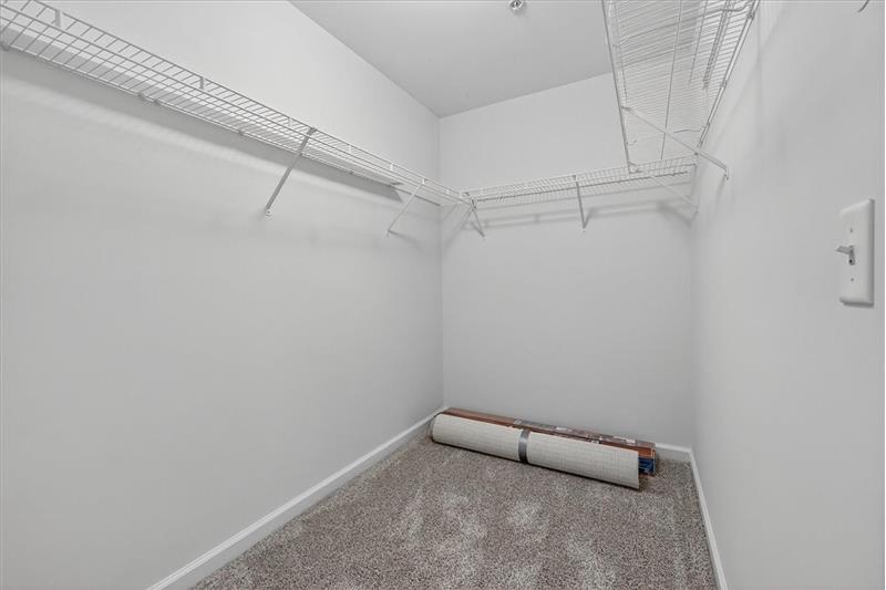 Walk in closet primary bedroom