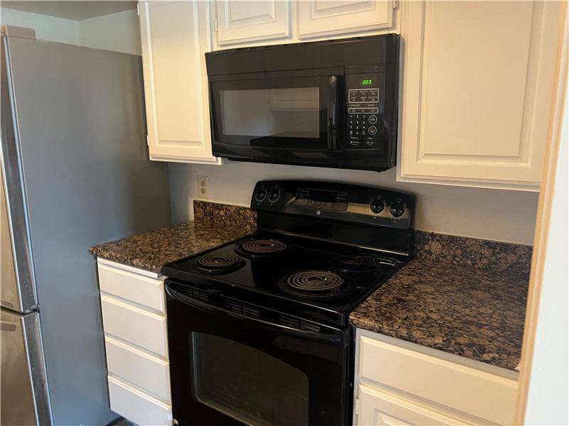 Black Electric Range and Microwave & Matching Dishwasher.