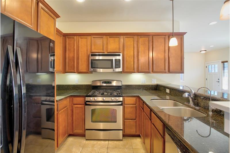 Granite counters. Stainless appliances. And that nice refrigerator can stay, if you like. Just 'ask for it' in your offer.