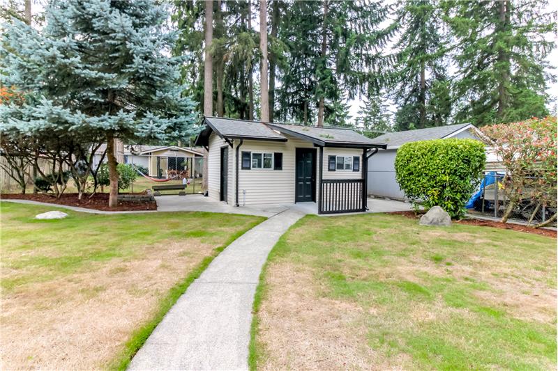 paved sidewalk to the outbuilding