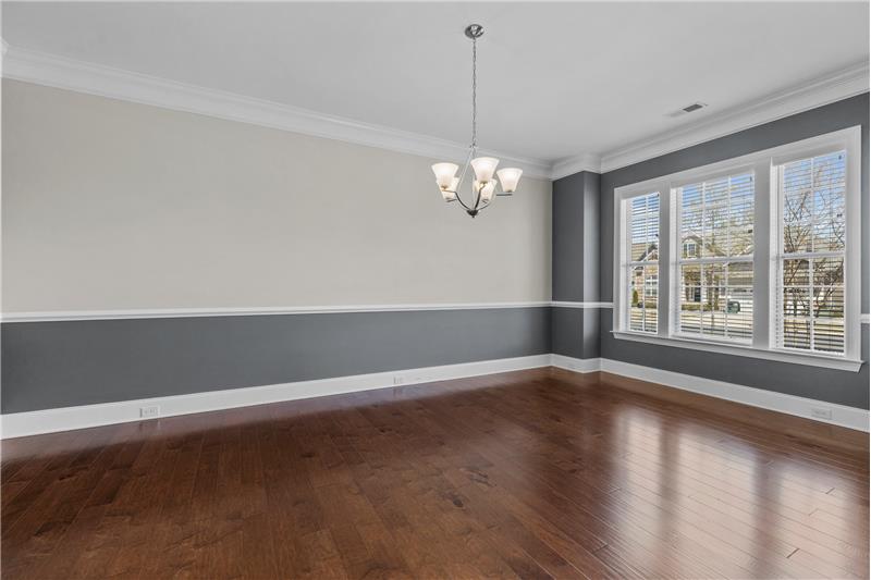 Dining Room: spacious dining room features gleaming hardwood floors, crown molding, chair rail, triple windows.
